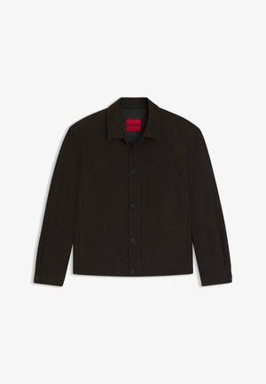 Black button-up jacket with a collar, two front pockets, and contrasting red label inside. Features a smooth texture and tailored fit.