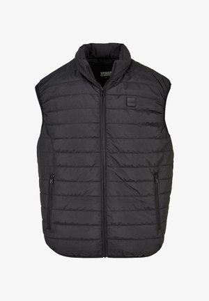 Čierna bezrukávová puff vest s vysokým golierom, so zipsom, dvoma bočnými vreckami, horizontálnym prešívaním a malou nášivkou loga na hrudi.