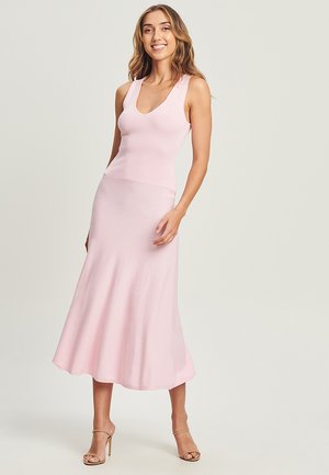 Light pink, ribbed, sleeveless maxi dress with a fitted bodice and flared skirt. Smooth texture, knee-length, minimalistic design.