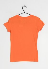 Orange cotton t-shirt with short sleeves, crew neckline, and a rectangular fabric patch on the upper back. Smooth texture.