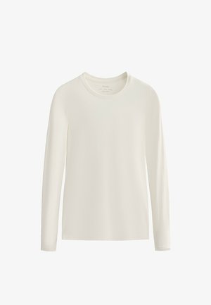 Long-sleeve shirt in off-white, made of soft fabric, featuring a crew neckline and a smooth, textured surface. No visible patterns or accents.