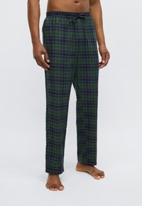 Grønne og mørkeblå ternede pyjamasbukser med løs pasform, elastisk taljebånd og snøre, med blødt stof og lige ben.