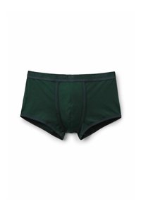 Boxer cortos de color verde oscuro fabricados en suave algodón, con una cinturilla elástica negra que presenta la inscripción "HUMAN" y detalles de costura contrastantes.