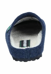 Navy wool felt slip-on shoe with a soft white inner lining, textured exterior, and black rubber sole. Features a green brand label on the side.