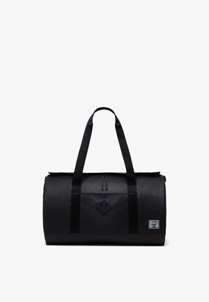Borsa duffel nera con doppi manici superiori, chiusura con zip, superficie liscia, forma rettangolare e un patch con logo a forma di diamante sul davanti.