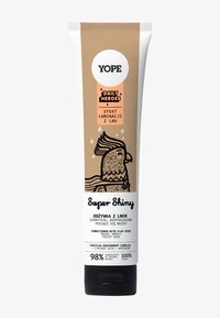 Tube de revitalisant Yope Super Shiny avec un dégradé beige à blanc, illustré d'un oiseau de dessin animé et de texte noir sur une finition mate.
