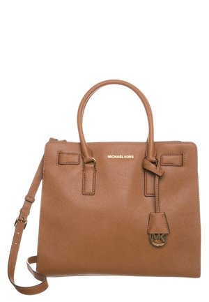 Bruine leren Michael Kors-handtas met dubbele handvatten, verstelbare schouderriem en gouden logohanger op een witte achtergrond.