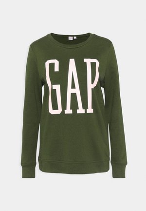 Zielona bluza z bawełny, z długimi rękawami i okrągłym dekoltem. Duże logo "GAP" w jasnoróżowym kolorze na przodzie.