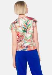 Korte mouwen blouse van lichtgewicht stof met kleurrijke tropische bladerenpatronen en groene, rode en blauwe accenten, achteraanzicht weergegeven.