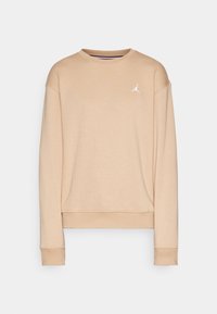 Sweatshirt beige à manches longues avec col ras du cou, petit logo Jumpman blanc sur le côté gauche de la poitrine, poignets et ourlet côtelés.