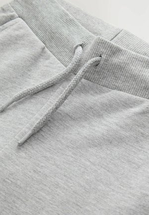 Hellgraue Jogginghose mit geripptem Bund, verstellbarem Kordelzug und weichem Material, geeignet für Freizeit oder Entspannung.