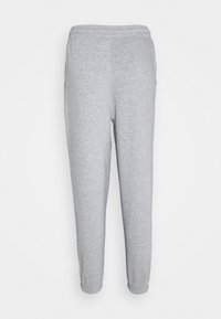Pantalones de chándal grises hechos de una tela suave y elástica. Cuentan con una cinturilla elástica, piernas ajustadas y sin bolsillos ni hardware visibles.