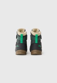 Black and green hiking boots with a plush tan lining, adjustable straps, and rubber soles, featuring branding on the heel and side.