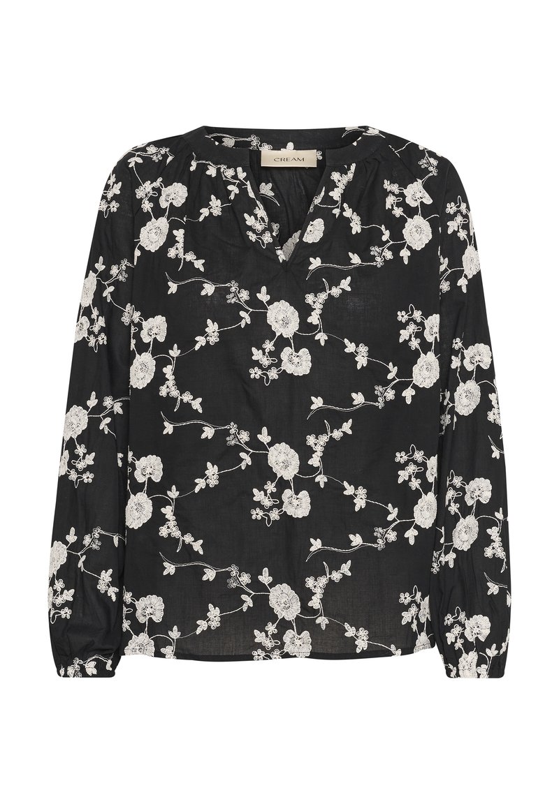 Blusa nera con scollatura a V e maniche lunghe, decorata con ricami floreali bianchi su tutta la superficie. Leggera con una finitura leggermente strutturata.