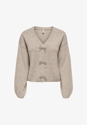 Suéter recortado beige con escote en V, tres lazos decorativos en la parte delantera y mangas largas abullonadas. Textura suave, diseño casual.