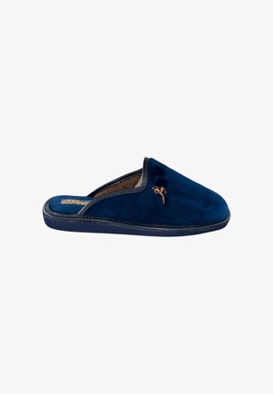 Zapatilla de terciopelo azul marino con textura suave, diseño sin cordones y costuras ligeras. Presenta un sutil acento bordado en la parte superior.