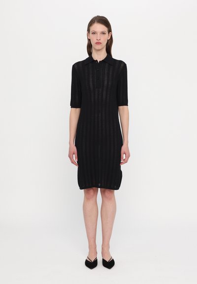 Black knitted dress with a buttoned collar, short sleeves, and vertical stripe pattern. Fitted design and knee-length cut.