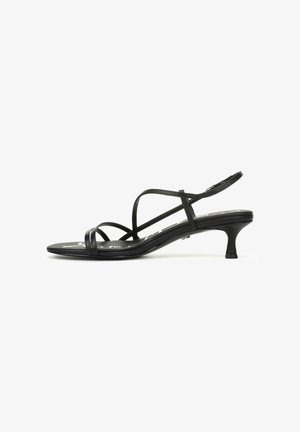 Sandali neri con cinturini sottili e tacco slim. Caratterizzati da cinturini stretti e una texture liscia. Design con punta aperta, minimalista con una silhouette elegante.