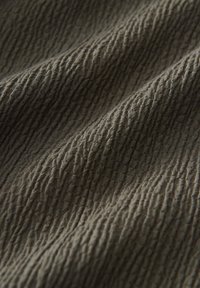 Textured fabric in dark green with subtle vertical ripples; smooth with a slight sheen, showcasing intricate patterns.