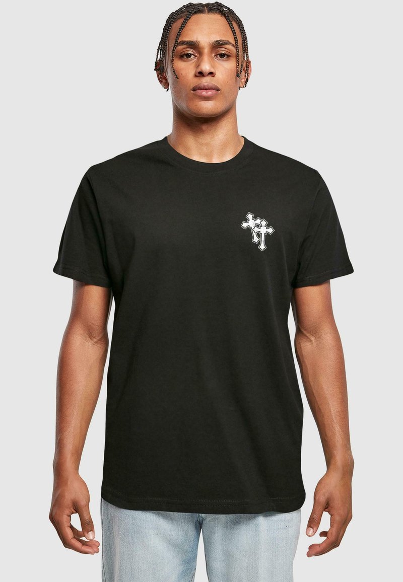 T-shirt en coton noir à manches courtes, avec un petit design graphique blanc sur la poitrine gauche. Coupe droite, ajustement décontracté.