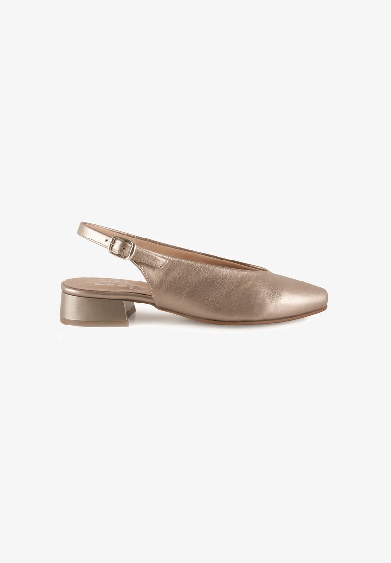 Zapato slingback de cuero metálico beige, con punta afilada y un tacón bajo y cuadrado. Correa ajustable con un pequeño detalle de hebilla.