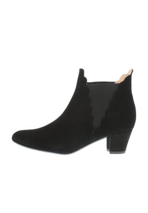 Black suede ankle boot with scalloped edge, pointed toe, elastic panels, and a low, chunky heel. Smooth texture with a matte finish.
