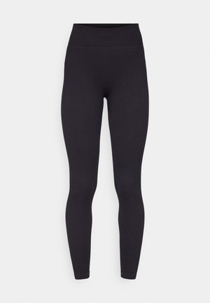 Leggings neri con una texture a coste, vita alta e silhouette aderente, realizzati in materiale elasticizzato. Lunghezza alla caviglia senza accenti aggiuntivi.