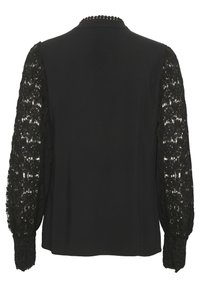 Black blouse featuring solid fabric with sheer lace long sleeves, adorned with intricate floral patterns, and a round neck with decorative trim.