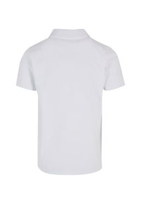 Lyhythihainen polo-paita valkoisesta puuvillasta, jossa on klassinen kaulus, tasaista rakennetta ja siisti, minimalistinen muotoilu.