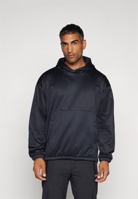 Felpa con cappuccio in tessuto blu navy scuro, caratterizzata da una vestibilità ampia e rilassata, cappuccio con coulisse, tasca frontale e polsini e orlo elasticizzati.