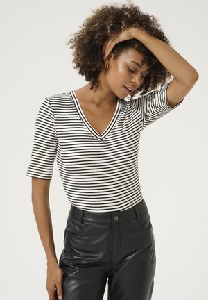 Black and white striped short-sleeve V-neck top, ribbed texture, paired with high-waisted black faux leather pants, slim-fit design.