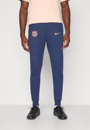 Mornarsko modri trenirki z oprijetim dizajnom, ki imata vezeno logo in rožnato Nike žogo. Teksturovana tkanina s zoženimi nogami.