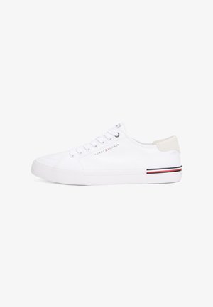 White low-top sneaker with laces, a beige heel tab, and Tommy Hilfiger logo and stripes on the side and midsole.