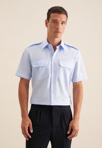 Camicia azzurro chiaro a maniche corte realizzata in tessuto intrecciato, dotata di due tasche sul petto, chiusura frontale con bottoni e design del collo classico.