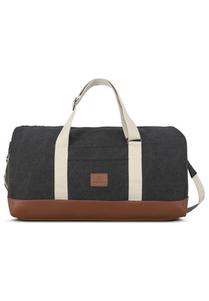 Dark gray fabric duffel bag with cream straps and brown leather bottom. Features a logo patch and zipper closure. Compact rectangular shape.
