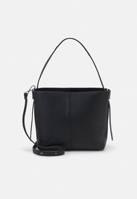 Black leather tote bag with a structured design, adjustable long strap, and a short top handle. Smooth texture and minimalistic aesthetic.