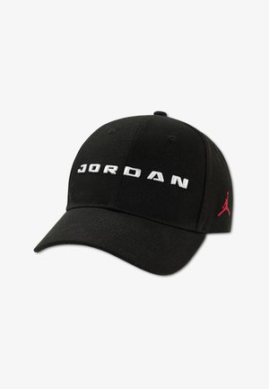 Black cap with "JORDAN" embroidered in white across the front. Features a red Jumpman logo on the side and a curved, textured brim.