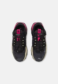 Baskets de sport noires avec une finition texturée, des accents roses et une semelle épaisse. Comprend un col rembourré, des lacets ajustables et une pointe renforcée.