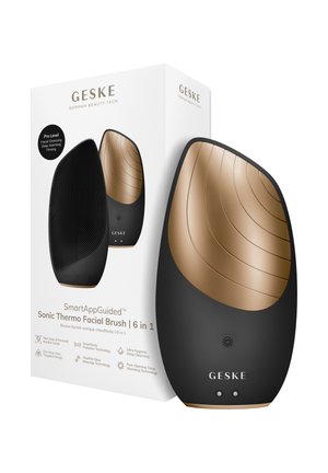 Strakke zwarte en gouden sonische thermo gezichtsborstel met getextureerde haren, naast witte verpakking met details over 6-in-1 huidverzorgingsfuncties.