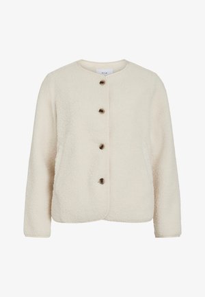 Hallhalli jope koššusvalges, ümmarguse kaelusega, nelja pruuni nupuga ja pikkade varrukatega, millel on pehme tekstuur.