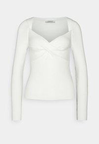 Haut blanc à manches longues côtelées avec un col en V profond et un design torsadé à l'avant. Silhouette ajustée avec une texture lisse et un minimum de coutures apparentes.