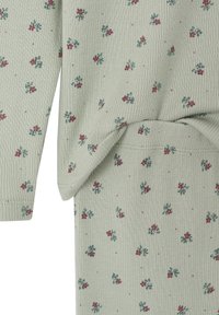 Light green ribbed knit fabric with small red and blue floral pattern on sleeve and torso sections of a garment.