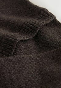 Dark brown knitted wool fabric featuring a ribbed texture with a wavy edge. The surface is slightly fuzzy, suggesting soft warmth.