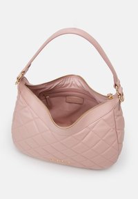 Quilted pink leather handbag with a rounded shape, golden hardware accents, and a zipper closure. Interior features a small zip pocket.