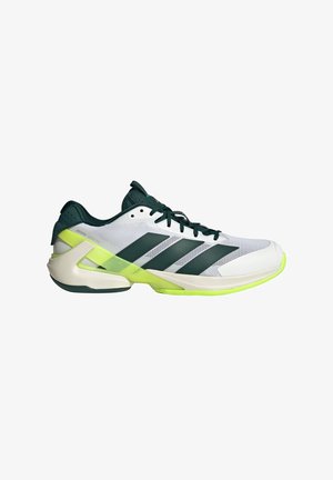 White athletic shoe with dark green accents, three diagonal stripes, mesh upper, and a lime green sole. Features a sleek design and cushioning.