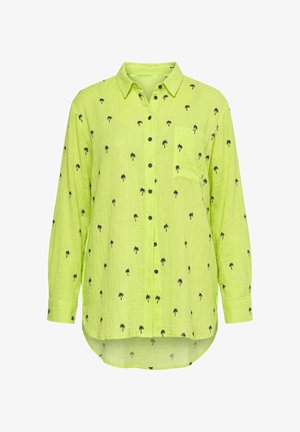 Langærmet limegrøn skjorte med knapper og små sorte palme mønstre samt en brystlomme på venstre side.