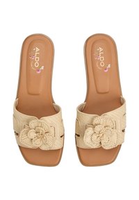 Infradito beige con design intrecciato, dettaglio floreale e soletta imbottita. Suola piatta con lati aperti per una maggiore traspirabilità.