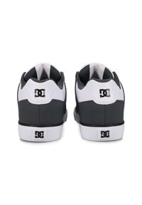 DC shoes with a gray and white color scheme, made of synthetic material. Features a low-top design and rubber sole with logo accents.