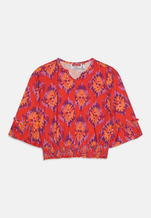 Top corto rojo con estampado abstracto en púrpura y naranja, escote en V, mangas tres cuartos con detalle de volante y cintura elástica fruncida.