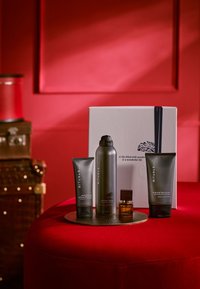 Fyra skötselprodukter från Rituals visade på en rund metallbricka: en kol-skrubb, koffeinshampo, duschskum och en liten parfym.